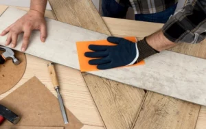 This image depicts a men installing Hardwood Flooring